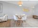 Dining area with a glass-top table and modern chairs, illuminated by a stylish pendant light at 5300 S Atlantic Ave # 5-502, New Smyrna Beach, FL 32169