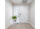 Inviting entryway with tiled floors, closet, and white front door with sidelight window at 5300 S Atlantic Ave # 5-502, New Smyrna Beach, FL 32169