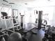 Well-equipped community gym with modern exercise machines, weights, and ample natural light at 5300 S Atlantic Ave # 5-502, New Smyrna Beach, FL 32169