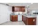 Kitchen featuring granite countertops, dark wood cabinets, and stainless-steel appliances at 5300 S Atlantic Ave # 5-502, New Smyrna Beach, FL 32169