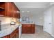 Kitchen featuring granite countertops, wood cabinets, and stainless-steel appliances at 5300 S Atlantic Ave # 5-502, New Smyrna Beach, FL 32169