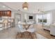 Bright living area with modern furniture, dining table, and access to a patio with a view at 5300 S Atlantic Ave # 5-502, New Smyrna Beach, FL 32169