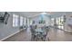 Bright lounge area with dining tables, comfortable seating, and charming nautical decor under a skylight at 5300 S Atlantic Ave # 5-502, New Smyrna Beach, FL 32169