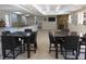 Resident lounge featuring dining tables, a kitchenette with bar seating, and a cozy fireplace area at 5300 S Atlantic Ave # 5-502, New Smyrna Beach, FL 32169