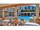 Beautiful community pool with covered seating, a charming fountain, and views of the surrounding buildings at 5300 S Atlantic Ave # 5-502, New Smyrna Beach, FL 32169