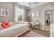 Bright bedroom with a daybed, desk, shelving, and a view of a window with white blinds at 5849 Ansley Way, Mount Dora, FL 32757
