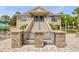 Beautiful community clubhouse featuring grand entrance with steps and lush landscaping at 5849 Ansley Way, Mount Dora, FL 32757