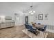Elegant dining room featuring a spacious table, stylish lighting, and a modern accent cabinet at 5849 Ansley Way, Mount Dora, FL 32757