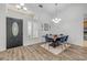 Dining room showcasing high ceilings, ample natural light, and stylish wood-look flooring at 5849 Ansley Way, Mount Dora, FL 32757