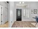Bright entryway with wood-look floors, a decorative door, and a view into the dining area at 5849 Ansley Way, Mount Dora, FL 32757