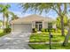 Charming single-story home with a manicured lawn, well-kept landscaping, and a two-car garage at 5849 Ansley Way, Mount Dora, FL 32757