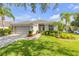 Beautiful single-story home with lush landscaping, a well-manicured lawn, and a welcoming entrance at 5849 Ansley Way, Mount Dora, FL 32757