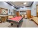 Clubhouse game room with a billiard table, carpeted floors, and wooden accents creating a relaxing entertainment space at 5849 Ansley Way, Mount Dora, FL 32757