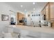 Bright kitchen featuring wood cabinets, stainless steel appliances, and a breakfast bar for casual dining at 5849 Ansley Way, Mount Dora, FL 32757