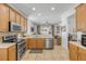 Bright kitchen with wooden cabinetry, stainless steel appliances, and an open layout at 5849 Ansley Way, Mount Dora, FL 32757