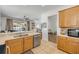 Open kitchen featuring wooden cabinets, a breakfast bar, and a view of the living room at 5849 Ansley Way, Mount Dora, FL 32757