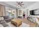 Spacious living room featuring sliding glass doors to pool and patio plus stylish furniture and decor at 5849 Ansley Way, Mount Dora, FL 32757