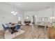 Open-concept living and dining area featuring hardwood floors, neutral paint, and ample natural light at 5849 Ansley Way, Mount Dora, FL 32757