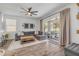 Cozy living room featuring a large sectional sofa and sliding glass doors to the patio at 5849 Ansley Way, Mount Dora, FL 32757