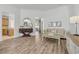 Bright living space featuring hardwood floors, contemporary furnishings, and views into other rooms at 5849 Ansley Way, Mount Dora, FL 32757