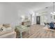 Comfortable living space featuring stylish furnishings, wood-look floors, and a well-lit dining area at 5849 Ansley Way, Mount Dora, FL 32757