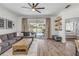 Open living room with a sliding glass door to the pool and stylish furniture, allowing seamless indoor/outdoor living at 5849 Ansley Way, Mount Dora, FL 32757