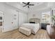 Bright main bedroom with a plush bed, bench seating, and modern decor at 5849 Ansley Way, Mount Dora, FL 32757