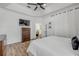 Large bedroom with a tray ceiling, ceiling fan, and view of the doorway to the kitchen at 5849 Ansley Way, Mount Dora, FL 32757