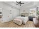 Calm bedroom featuring a tray ceiling, ceiling fan, and ample natural light at 5849 Ansley Way, Mount Dora, FL 32757