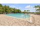 Expansive community pool with a brick surround and lush landscaping provides a resort-like atmosphere for residents at 5849 Ansley Way, Mount Dora, FL 32757
