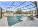 Outdoor pool area enclosed with screen, patio, and furniture for relaxation at 5849 Ansley Way, Mount Dora, FL 32757