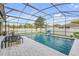 View of a screened-in pool with furniture and a patio area at 5849 Ansley Way, Mount Dora, FL 32757