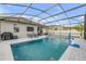 Covered pool with tile deck and outdoor dining area offers the ultimate backyard oasis at 5849 Ansley Way, Mount Dora, FL 32757