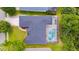 An aerial view shows the home's roof, screened pool, landscaping, and proximity to neighboring properties at 6065 Spruce Point Cir, Port Orange, FL 32128