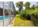 View of the screened enclosure, blending outdoor living and landscaping with access to the home, enhancing the property's appeal at 6065 Spruce Point Cir, Port Orange, FL 32128