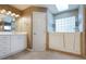 Primary bathroom featuring a walk-in tub, walk-in shower, double vanity, and lots of natural light at 6065 Spruce Point Cir, Port Orange, FL 32128