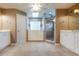 Spacious primary bathroom with double vanities, glass block window, and a walk-in shower at 6065 Spruce Point Cir, Port Orange, FL 32128