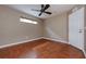 This bedroom features beautiful tile flooring, a ceiling fan, and a window for natural light at 6065 Spruce Point Cir, Port Orange, FL 32128