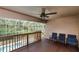 Spacious covered deck area with a ceiling fan, offering a view of the screened-in pool area at 6065 Spruce Point Cir, Port Orange, FL 32128