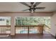 Relaxing covered deck area offering a glimpse of the screened-in pool and lush green landscape at 6065 Spruce Point Cir, Port Orange, FL 32128