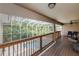 Expansive covered deck area with a ceiling fan, outdoor seating, and views of the screened-in pool at 6065 Spruce Point Cir, Port Orange, FL 32128