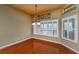 Dining room boasts gleaming wood floors, natural light from the windows, and a chandelier at 6065 Spruce Point Cir, Port Orange, FL 32128