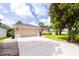 Well-maintained home with a spacious driveway, manicured lawn, and lush landscaping at 6065 Spruce Point Cir, Port Orange, FL 32128