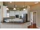 Bright kitchen with white cabinetry, stainless steel appliances, and a granite-topped island at 6065 Spruce Point Cir, Port Orange, FL 32128