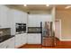 Kitchen featuring stainless appliances, granite counters and white cabinets at 6065 Spruce Point Cir, Port Orange, FL 32128