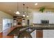 Modern kitchen featuring granite counters, stainless appliances, and white cabinetry at 6065 Spruce Point Cir, Port Orange, FL 32128