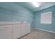 Clean laundry room with tile flooring, utility sink and storage cabinets at 6065 Spruce Point Cir, Port Orange, FL 32128