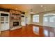 Well-lit living room with stone fireplace and a bright entry at 6065 Spruce Point Cir, Port Orange, FL 32128