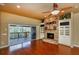 Inviting living room with stone fireplace and access to the outdoor deck at 6065 Spruce Point Cir, Port Orange, FL 32128