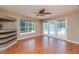 Open concept living space featuring tile floors, access to the pool, and a ceiling fan at 6065 Spruce Point Cir, Port Orange, FL 32128